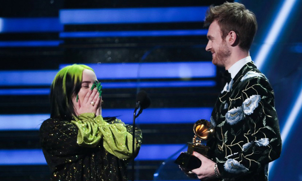 Billie cùng anh trai lên sân khấu nhận giải  "Ghi âm của năm ". Ảnh: Los Angeles Times. 