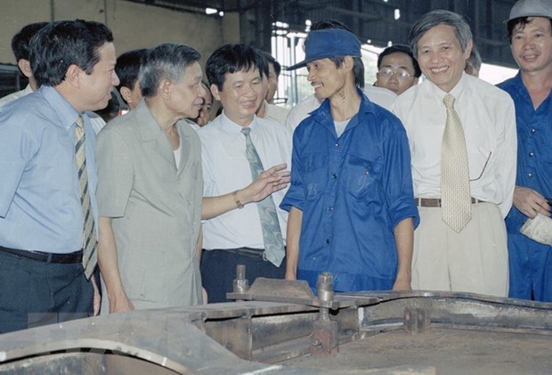 Tổng Bí thư Lê Khả Phiêu thăm hỏi công nhân phân xưởng đóng mới nhà máy xe lửa Gia Lâm, ngày 27/8/2000. (Ảnh: Anh Tôn/TTXVN)
