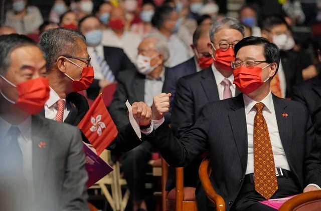 Đặc khu trưởng Hong Kong John Lee (phải), khi ấy còn là tổng thư ký, và Cục trưởng Tài chính Paul Chan vào năm 2021. Ảnh: AP.