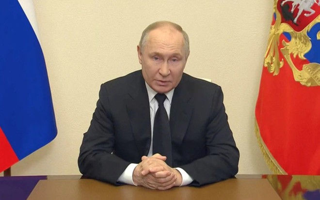 Tổng thống Nga Vladimir Putin trong bài phát biểu qua video trước toàn quốc ngày 23-3 - Ảnh: REUTERS/ĐIỆN KREMLIN

